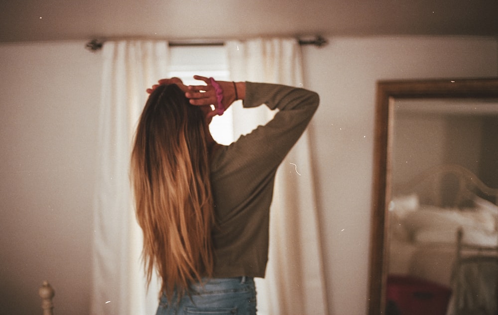 woman in gray long sleeve shirt and blue denim jeans