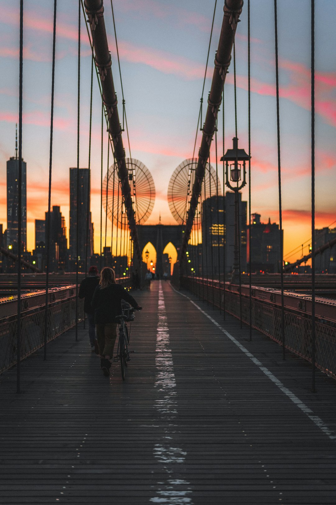 people walking on bridge during sunset