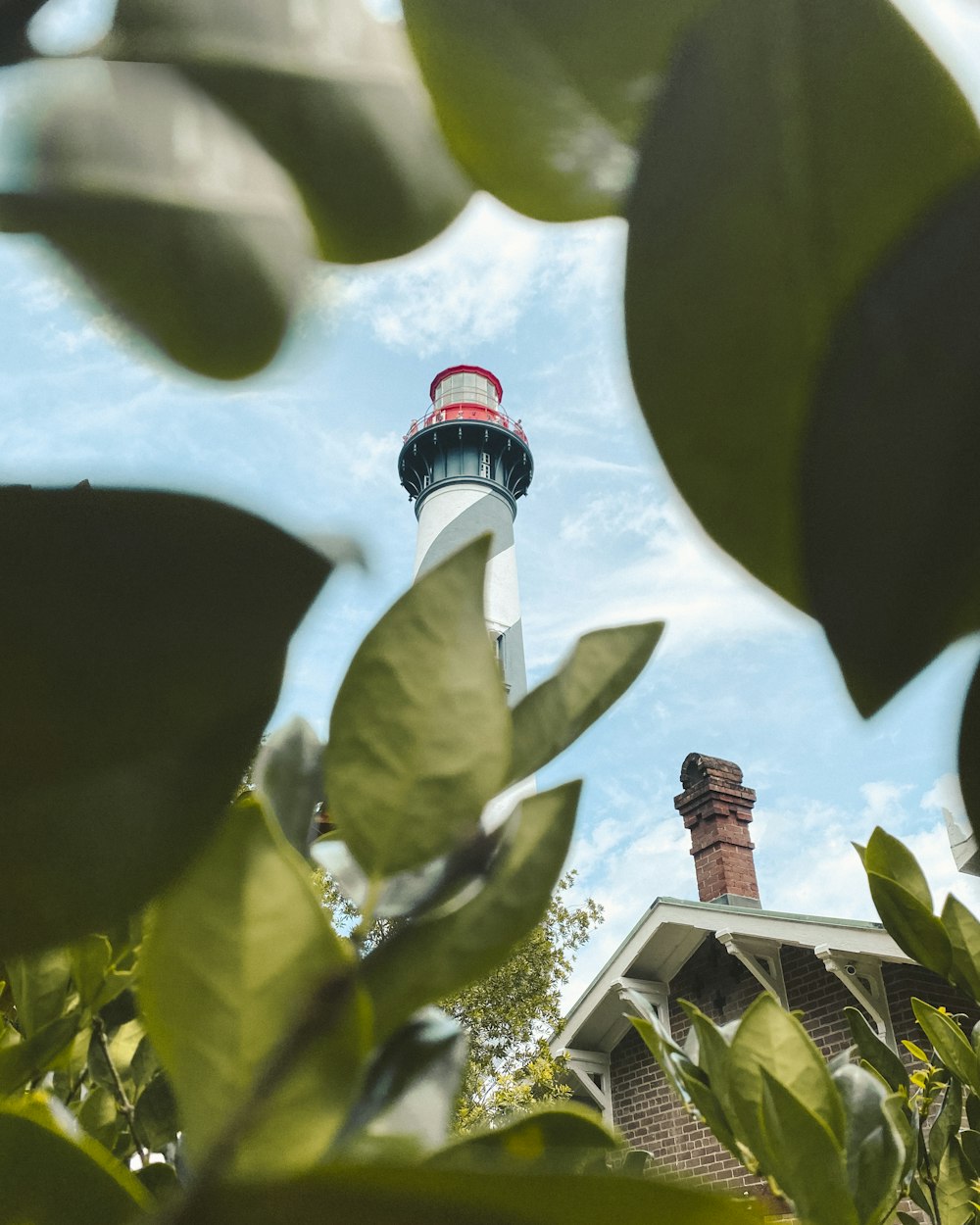 white and red lighthouse under blue sky during daytime