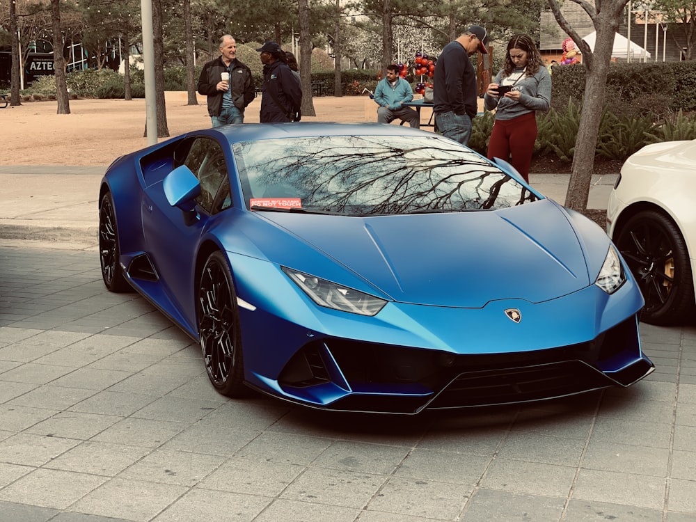 blue lamborghini aventador parked on gray concrete pavement