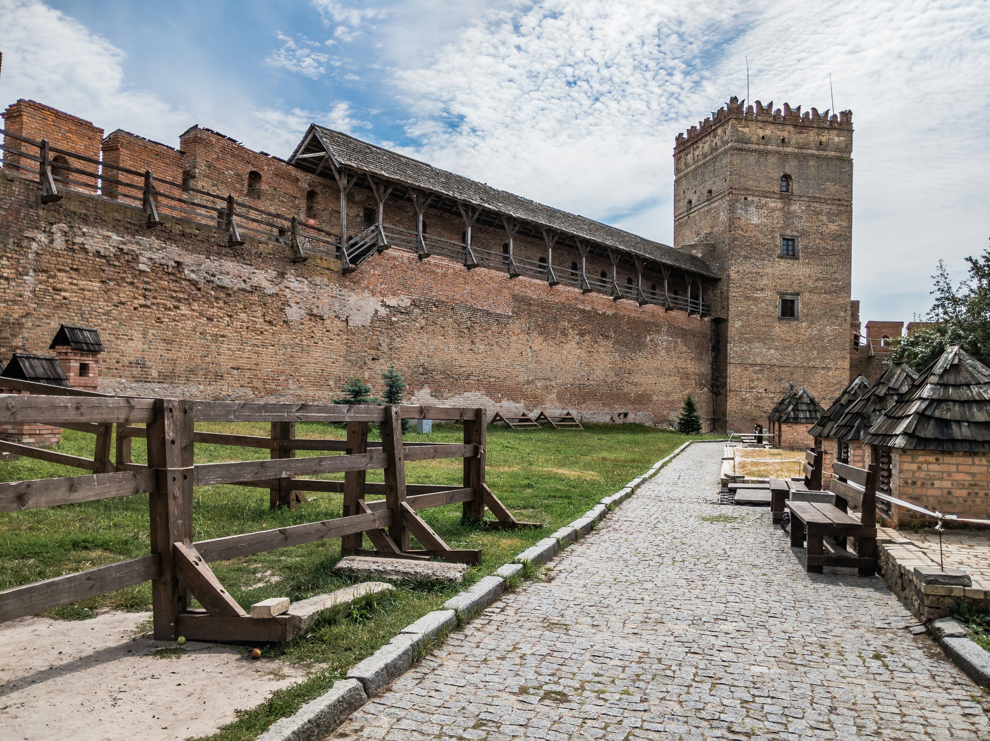 brown wooden bench near brown concrete building during daytime