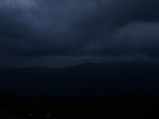 silhouette of mountains under cloudy sky during daytime in Bandipur Wildlife Sanctuary India