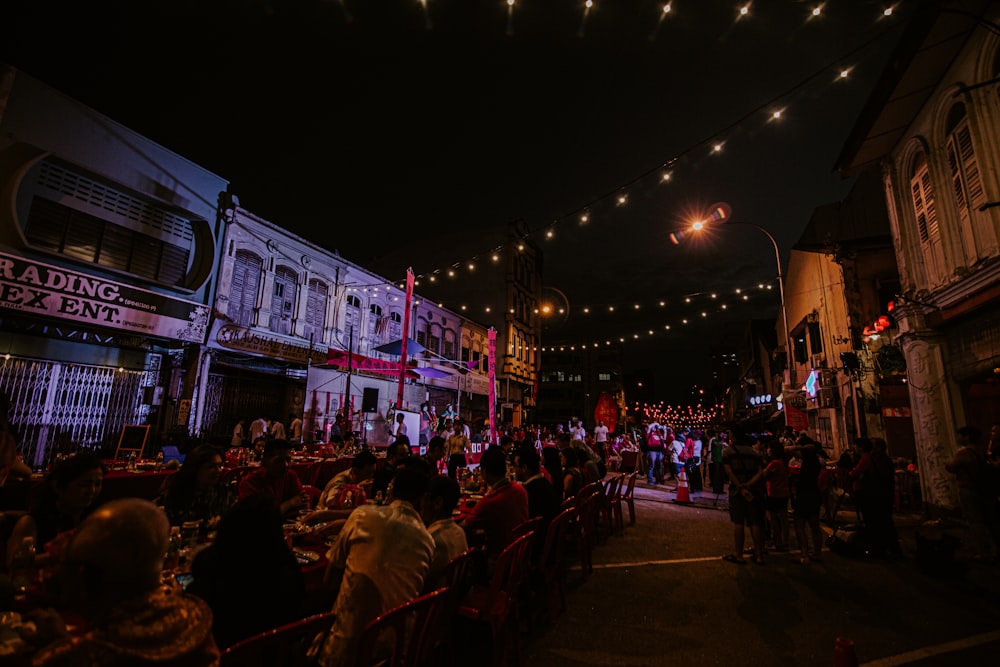 people gathering on street during night time