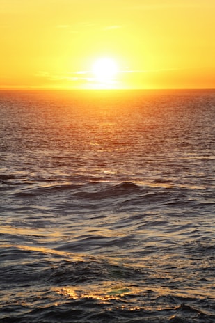 A vibrant sunset over a calm ocean, symbolizing harmony.