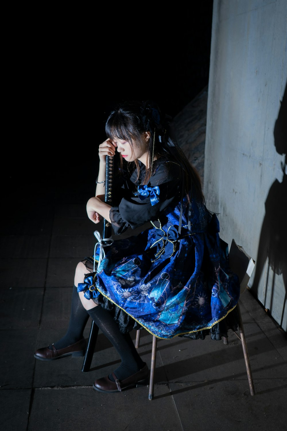 woman in black and blue dress sitting on chair