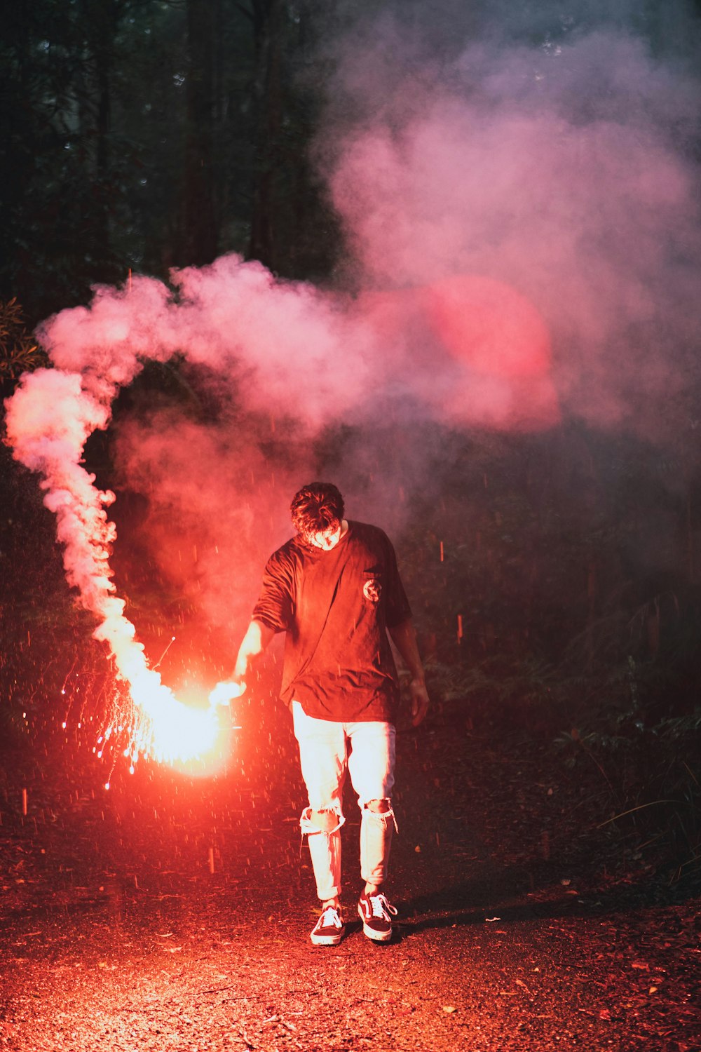 man in black jacket standing on fire