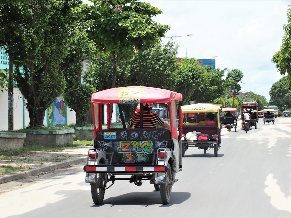 red and black auto rickshaw on road during daytime