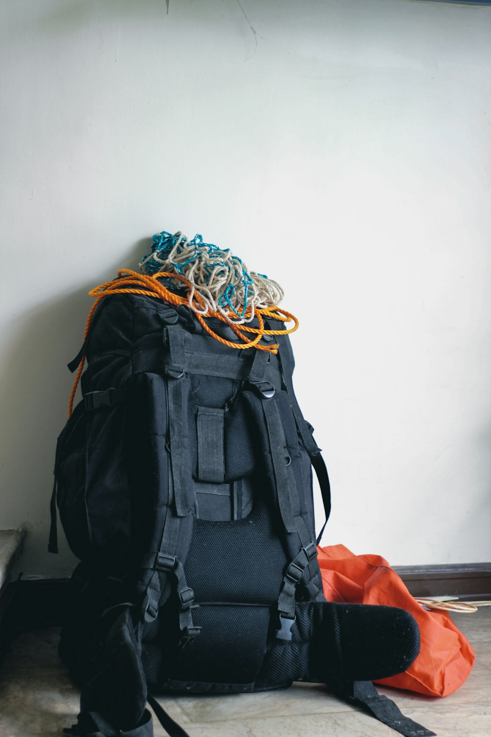 black backpack on orange textile