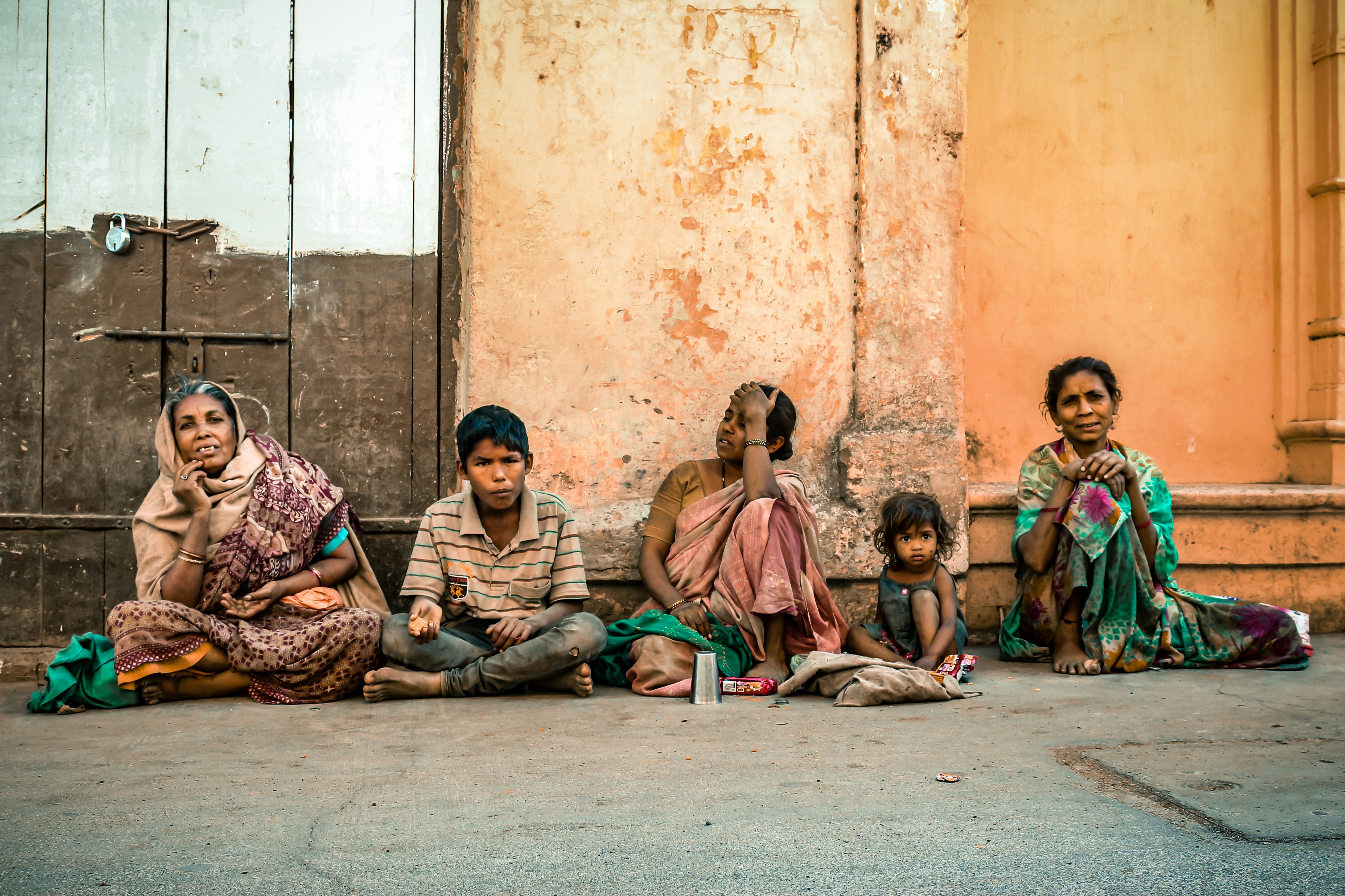 group of people sitting on concrete floor