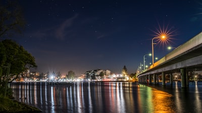 lighted bridge over river during night time