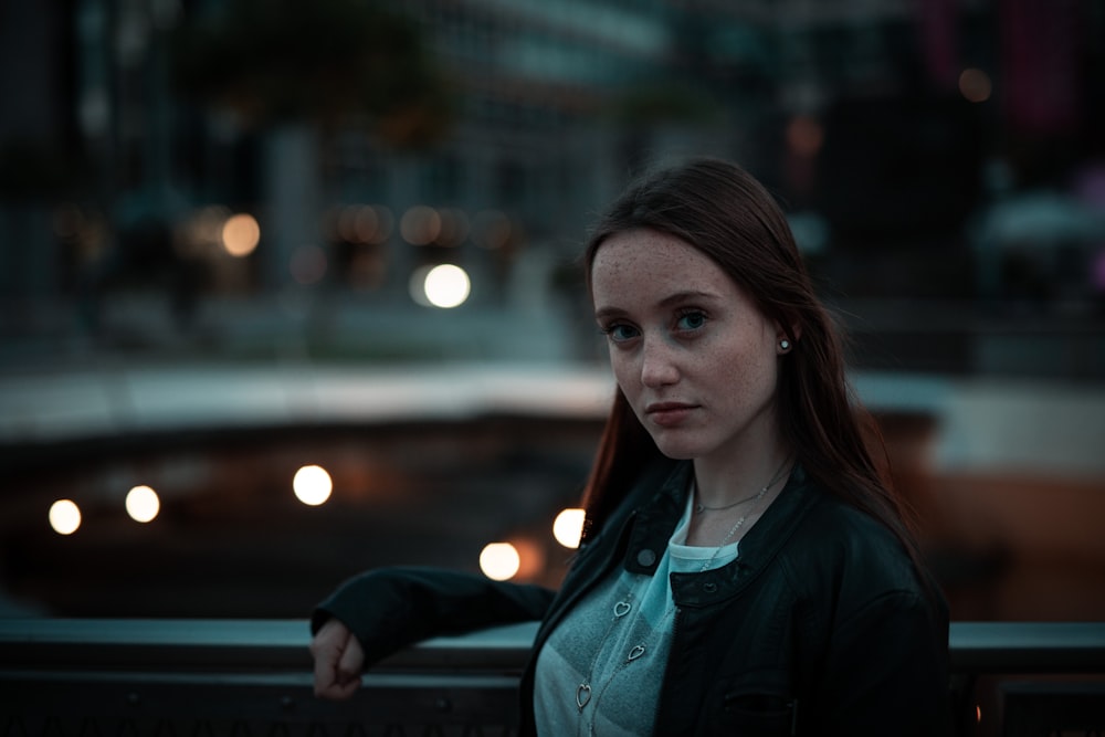 woman in black jacket looking at the right side