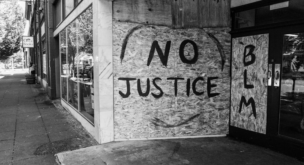 a sign on the side of a building that says no justice