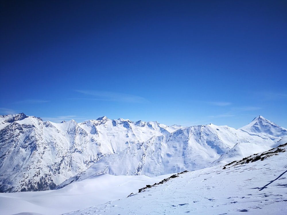 snow covered mountain under blue sky during daytime