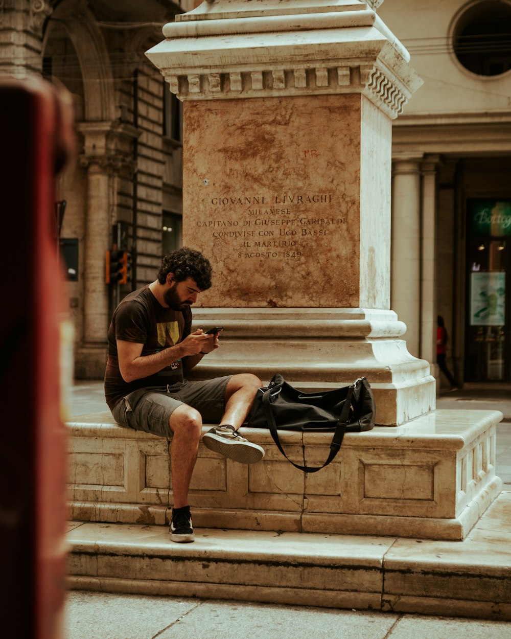 man in black t-shirt sitting on bench