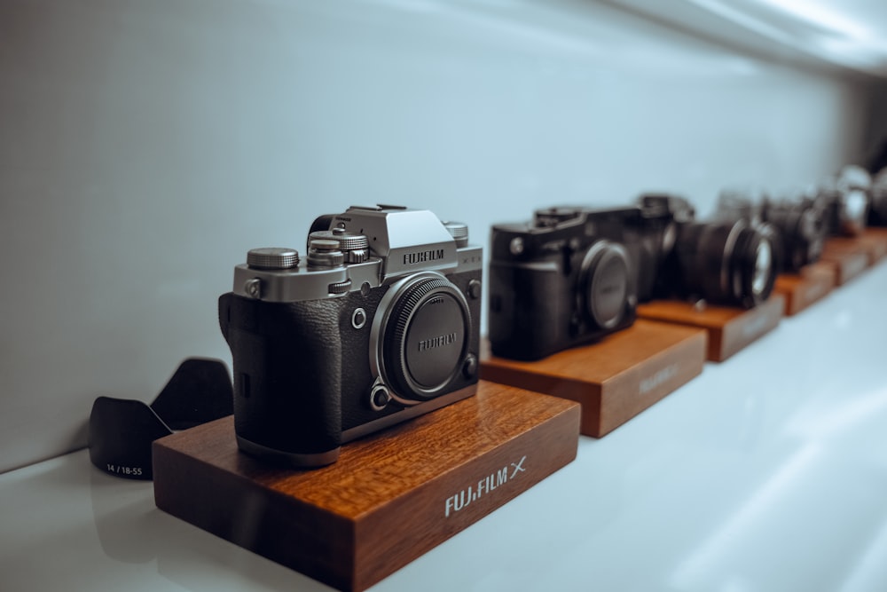 black and silver nikon dslr camera on brown wooden table