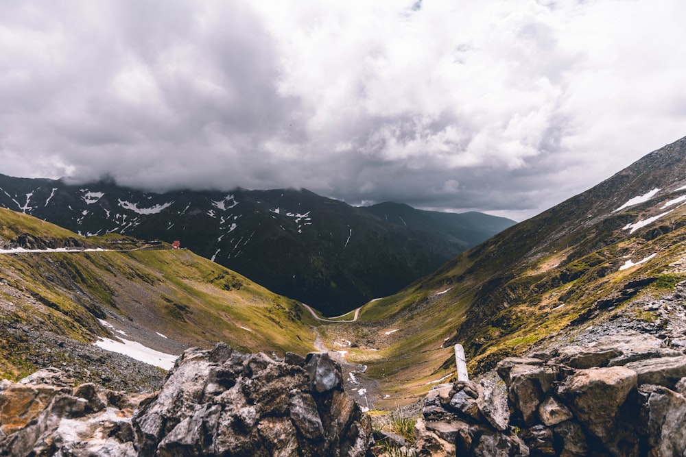 green and brown mountains under white clouds during daytime