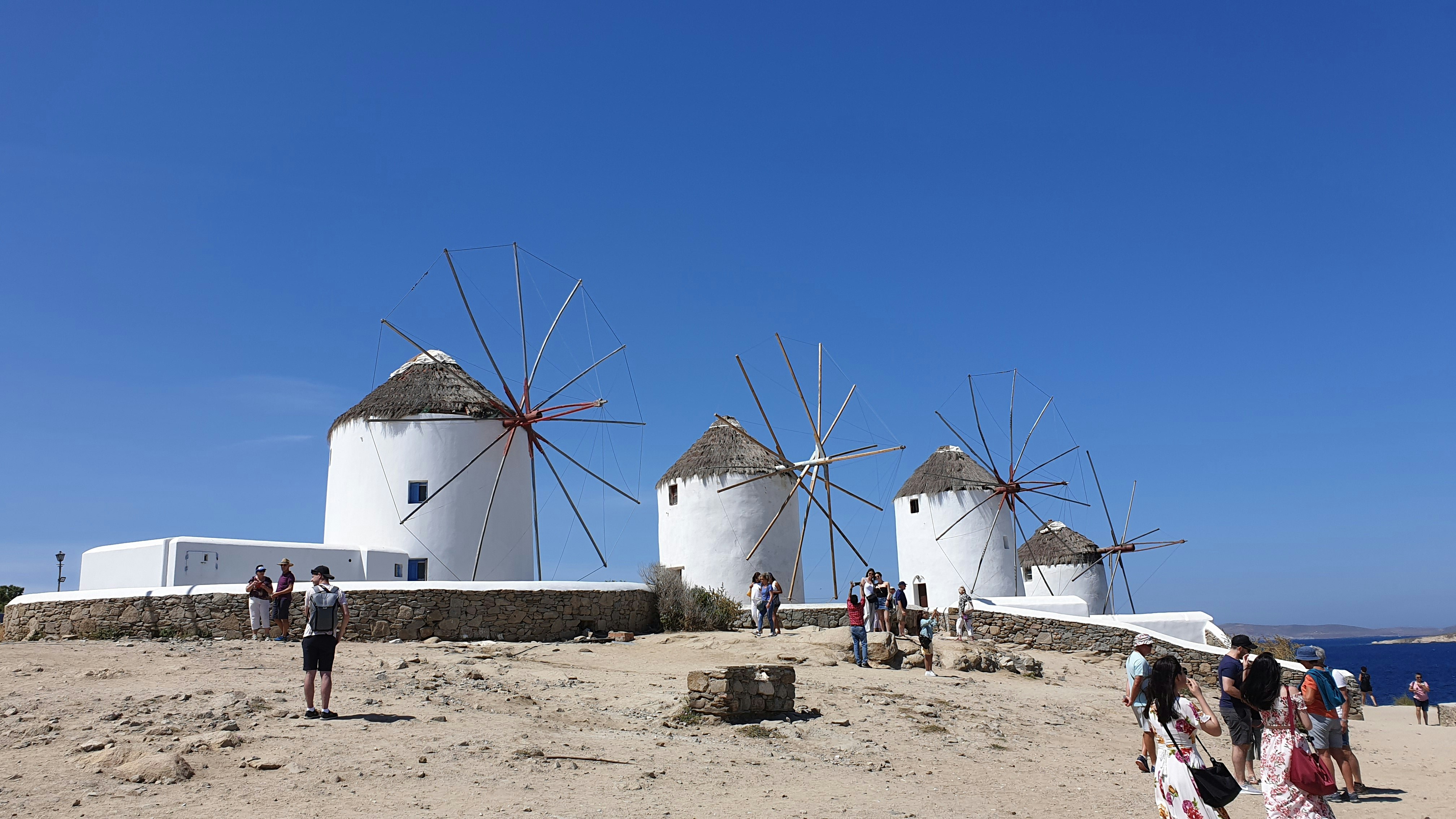 white and blue windmill under blue sky during daytime