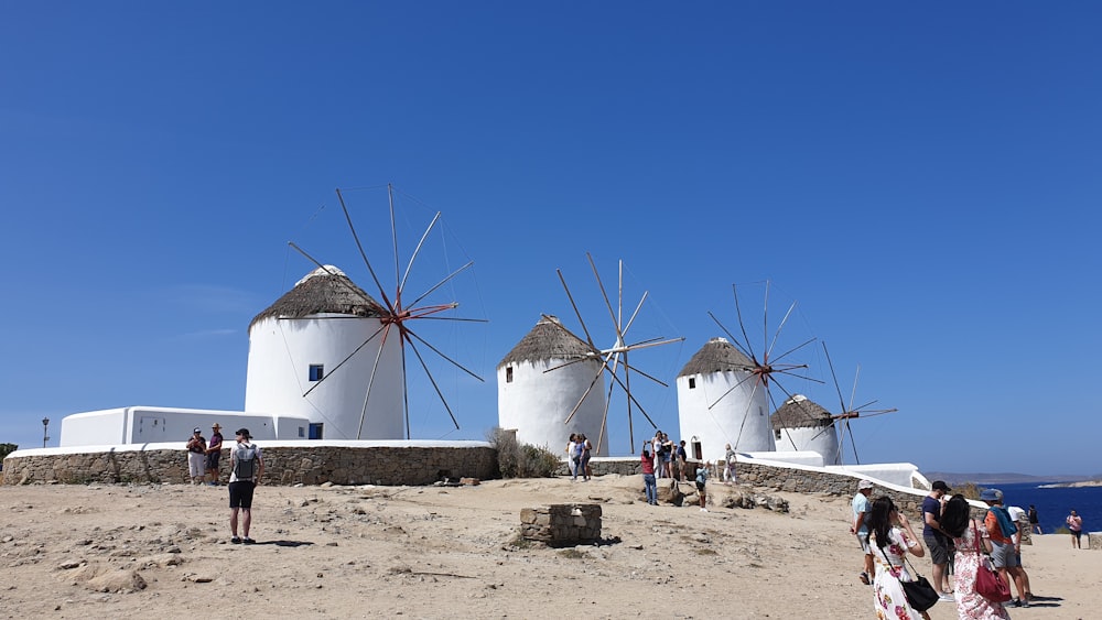 white and blue windmill under blue sky during daytime