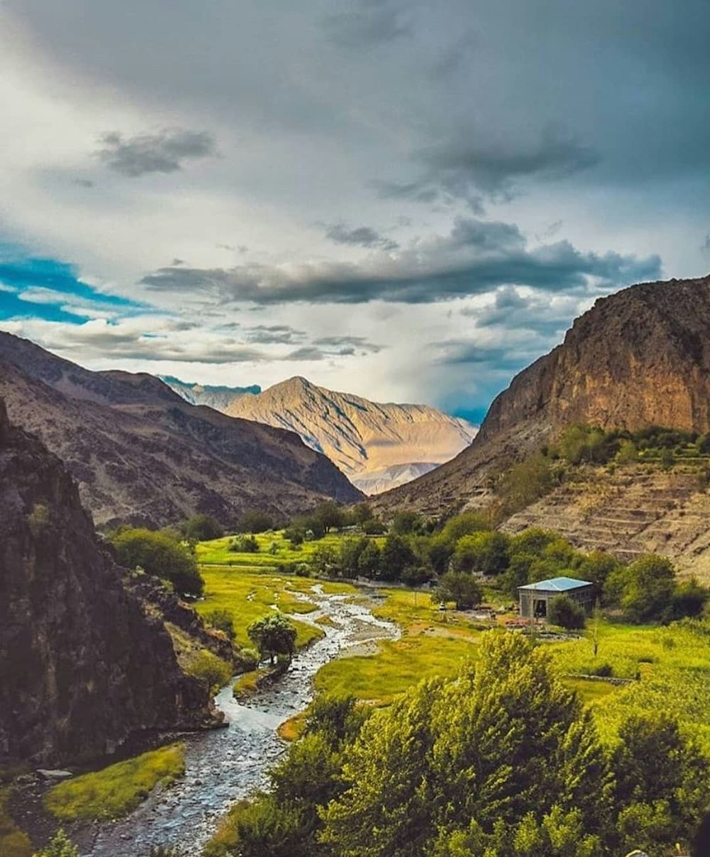 a river running through a lush green valley