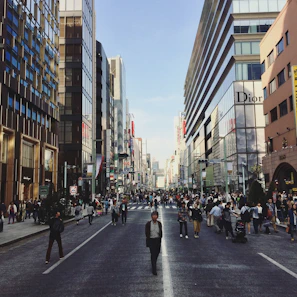 Wide-angle shot of a bustling street with multiple storefronts featuring clean, contemporary designs