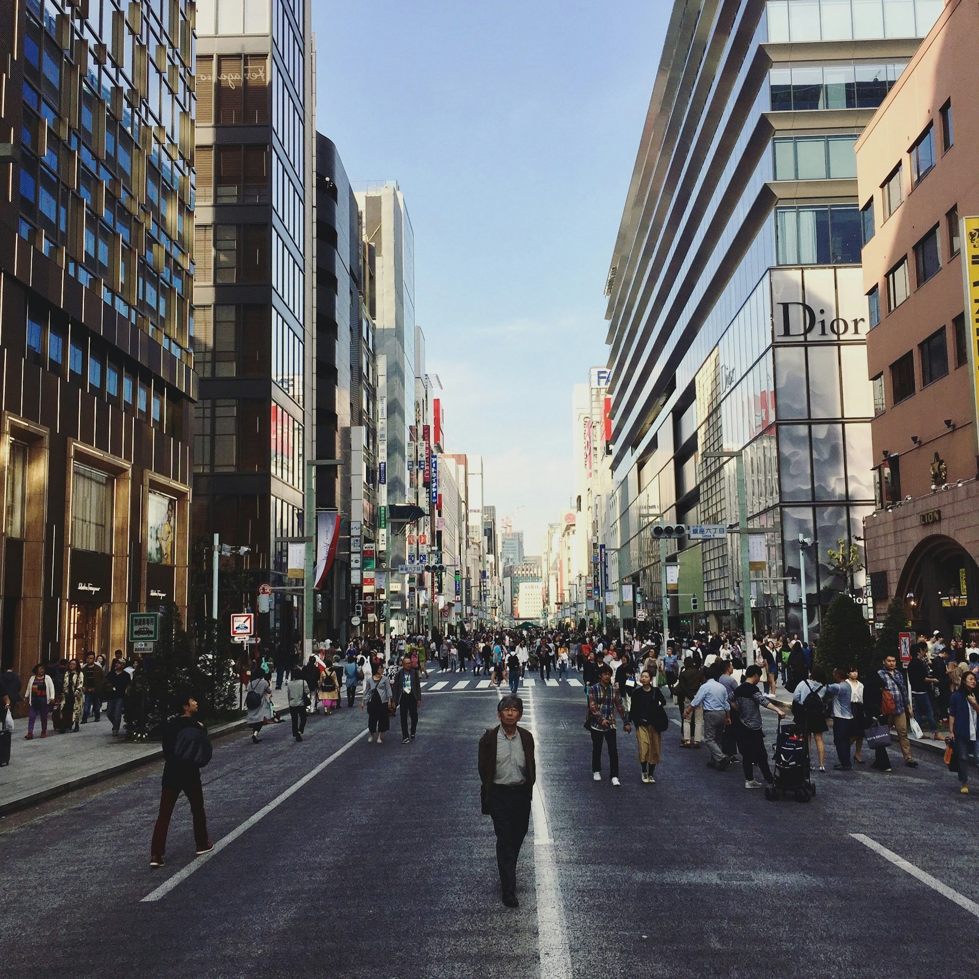 woman wearing yellow long-sleeved dress under white clouds and blue sky during daytime