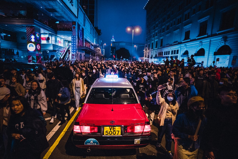 red car on road during night time