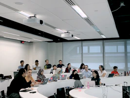 A modern classroom setting with students engaged in cloud infrastructure and SaaS software training.