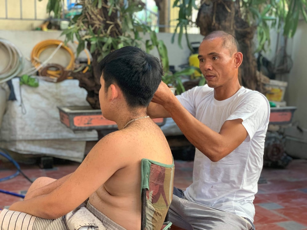 man in white crew neck t-shirt sitting beside man in white t-shirt