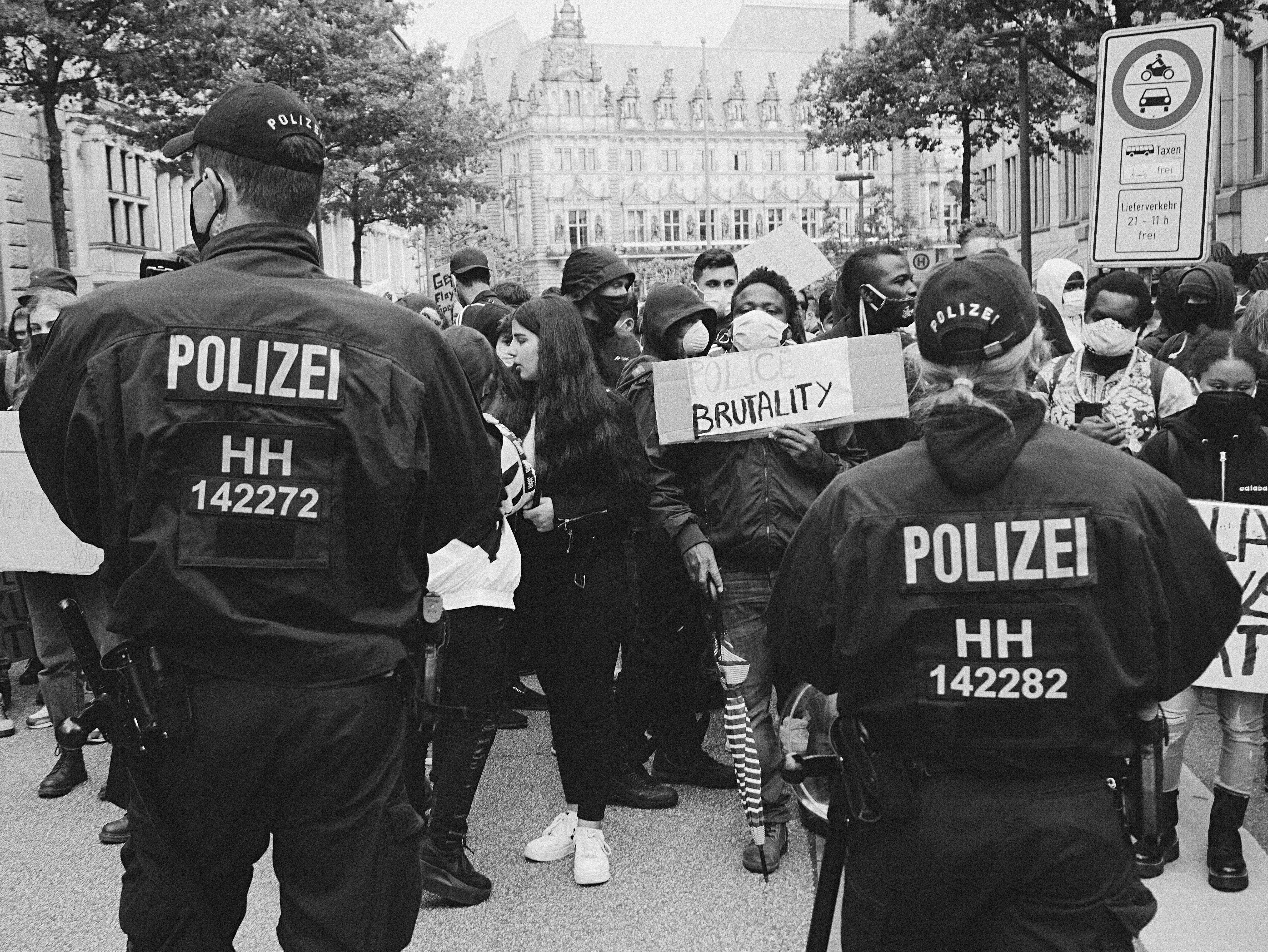 a group of police officers standing in front of a crowd of people