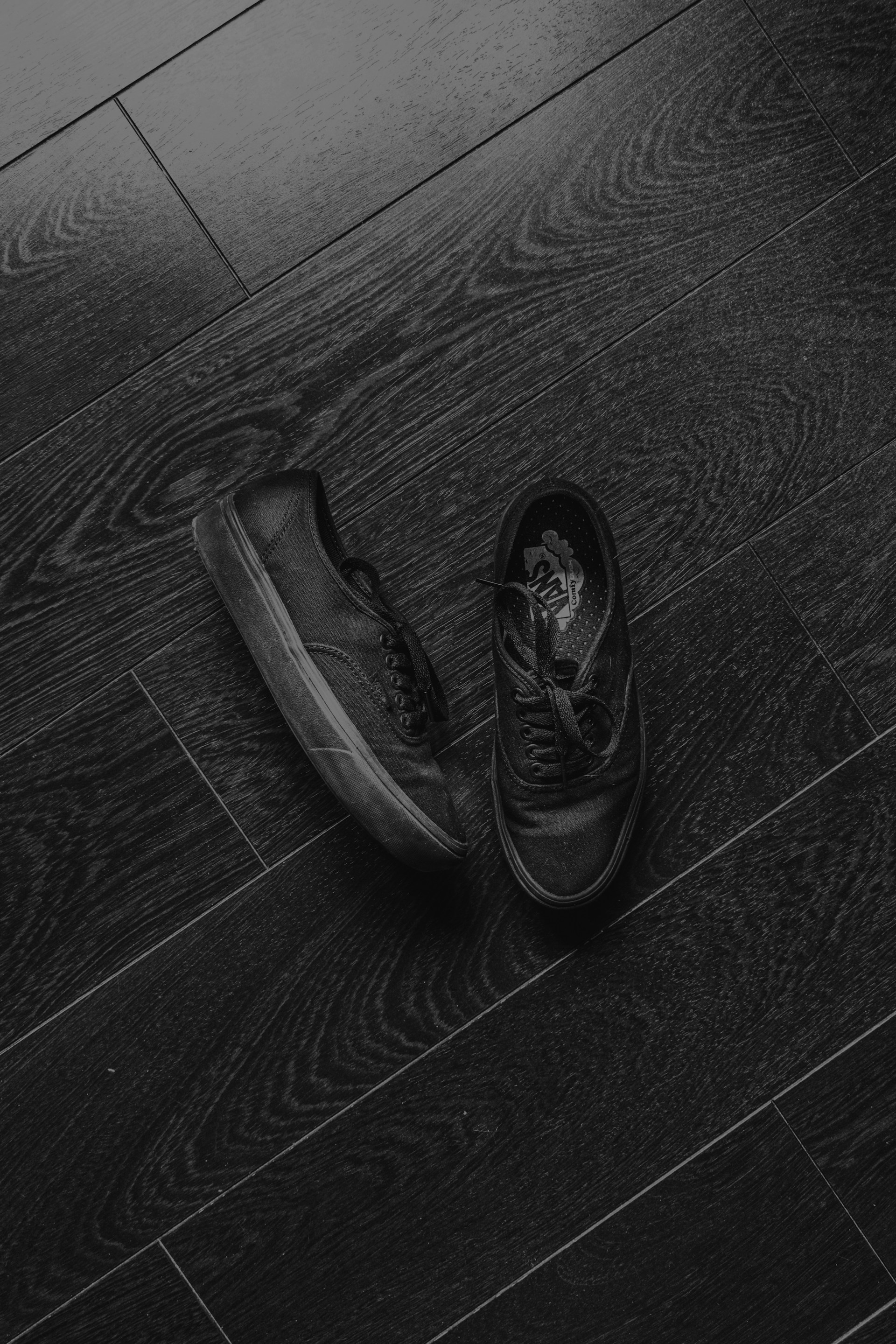 black leather shoes on black wooden floor