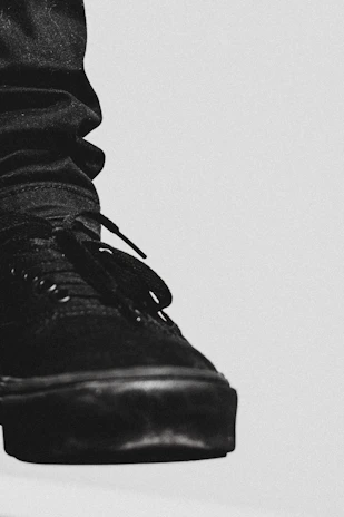 Close-up of a stylish black sneaker with modern details on a clean white background