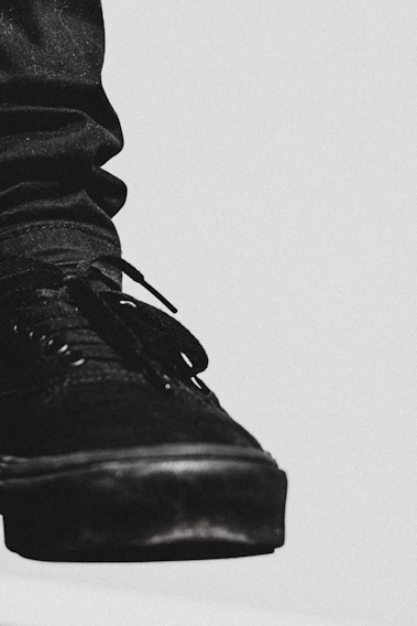 A crisp, black-and-white photo of a premium sneaker with clean lines and elegant stitching.