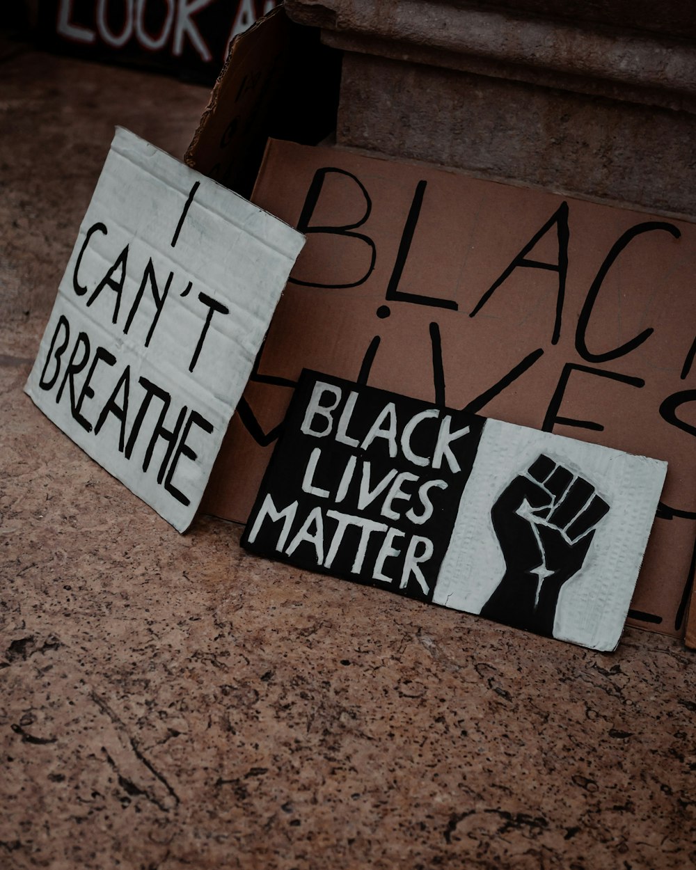 a group of protest signs sitting on top of a counter