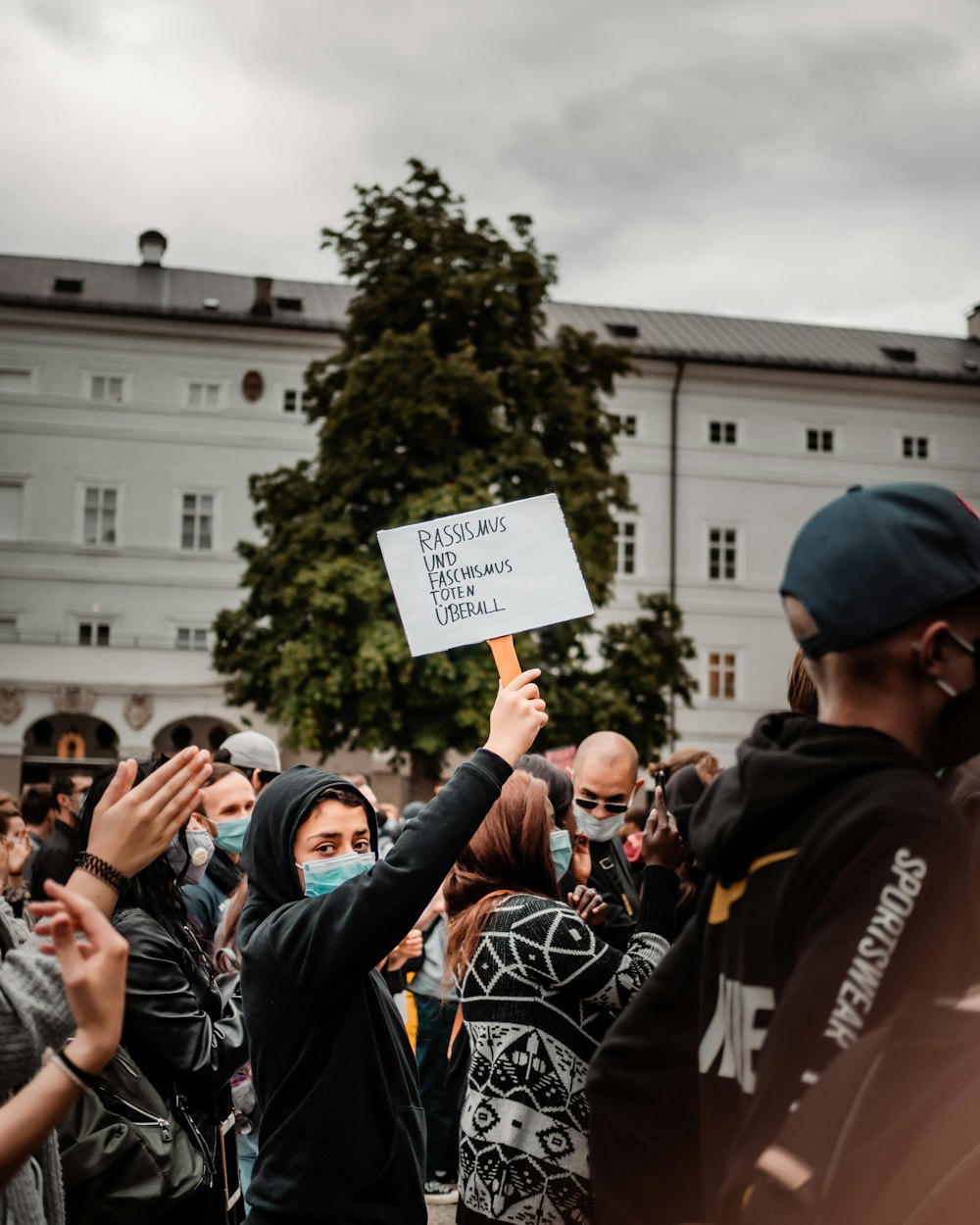 people holding white printer paper during daytime