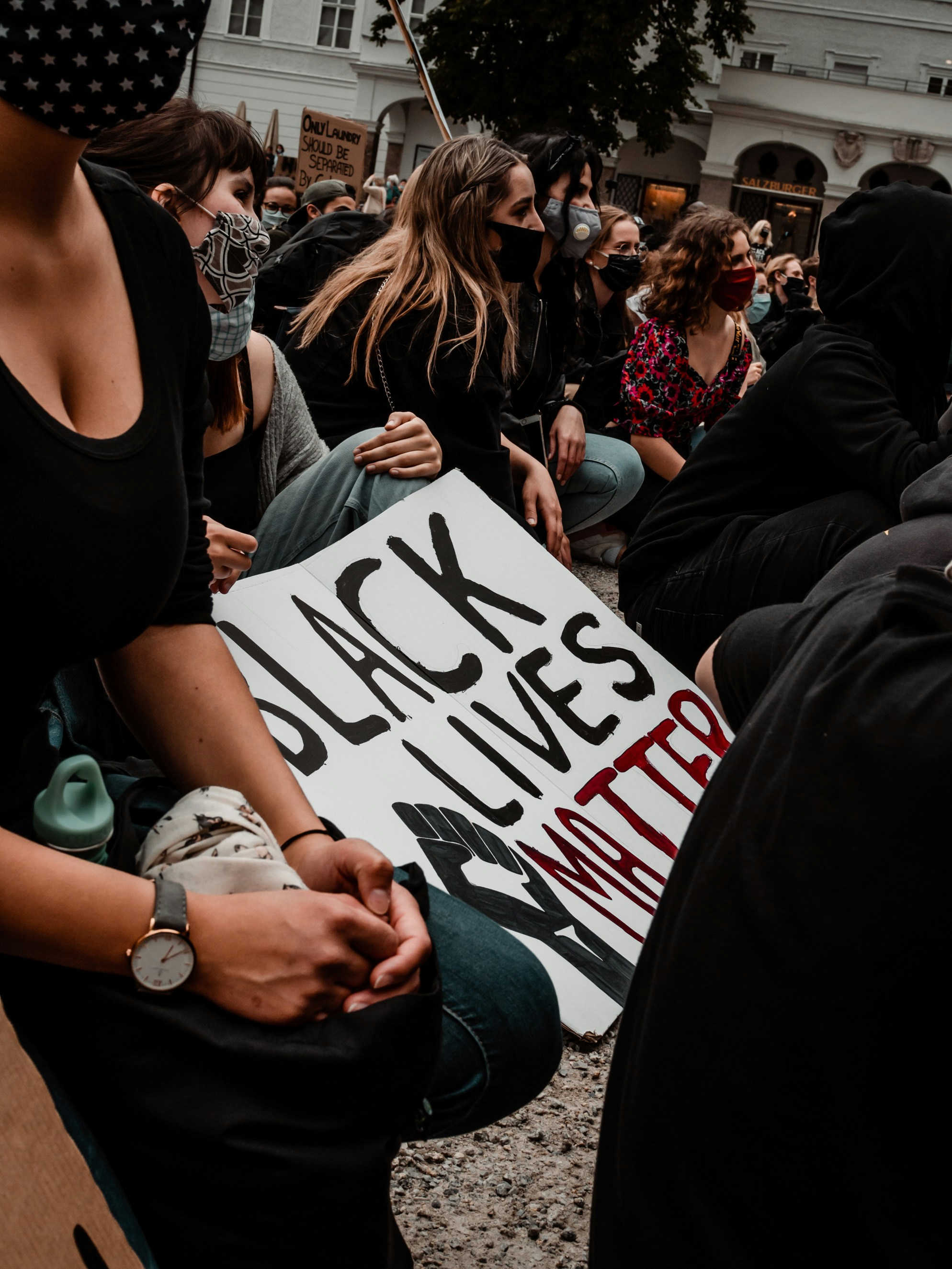 woman in black tank top holding white printer paper