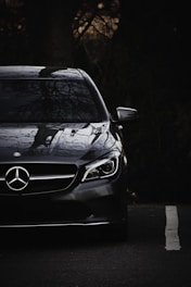 black mercedes benz c class on road during daytime