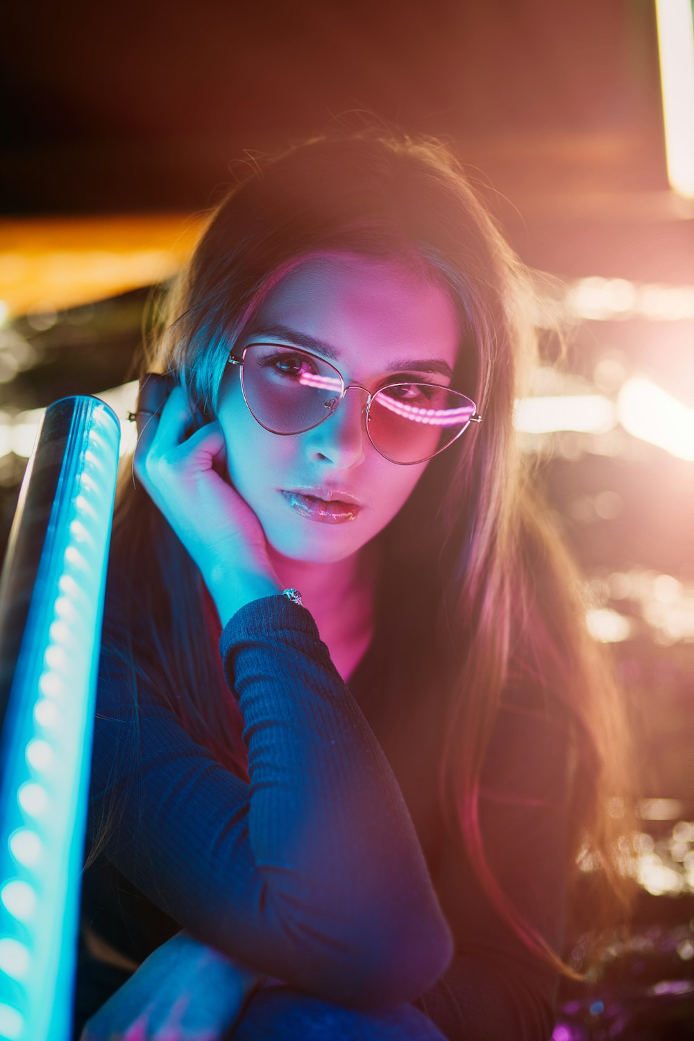 woman in blue sweater wearing eyeglasses