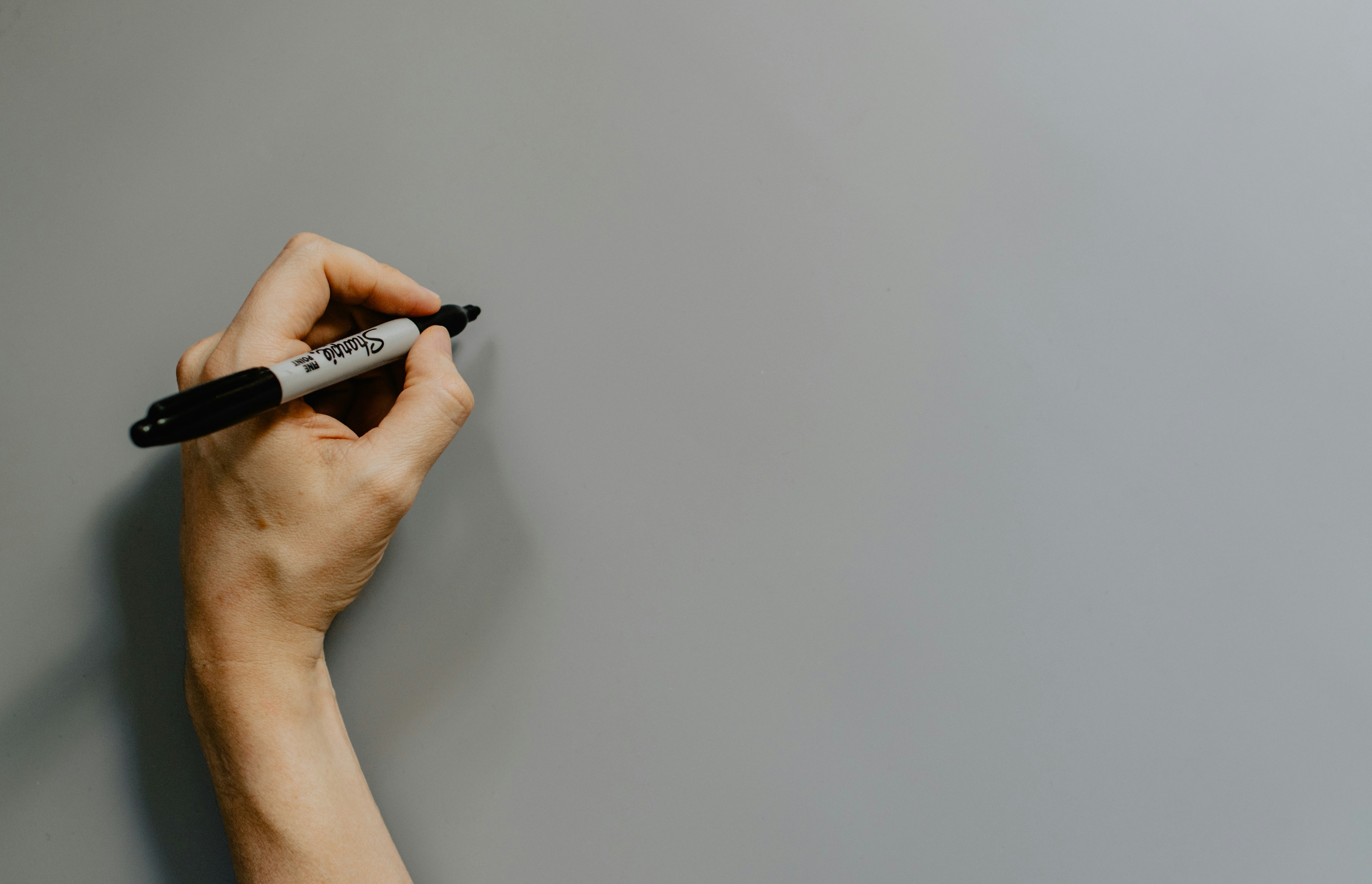 person holding black and white pen