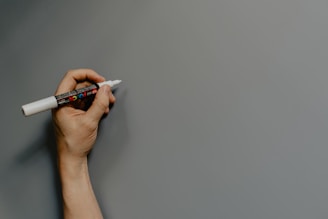 person holding black and white pen