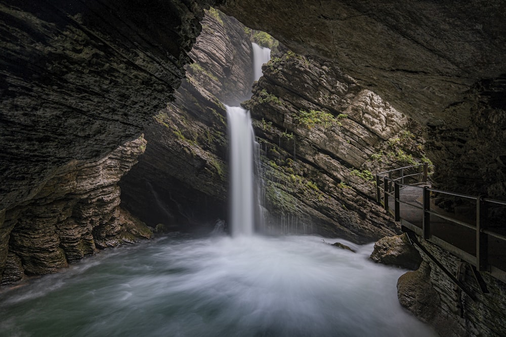 water falls on brown rocky mountain