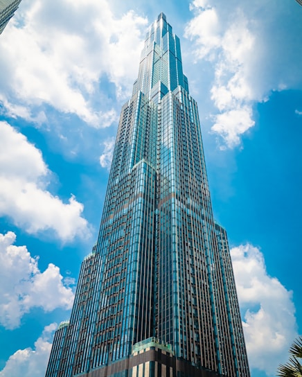 low angle photography of high rise building under blue sky during daytime