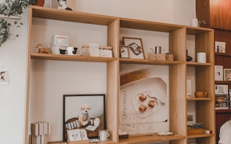 brown wooden shelf with figurines