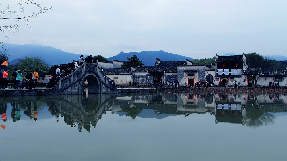 people walking on bridge over river during daytime