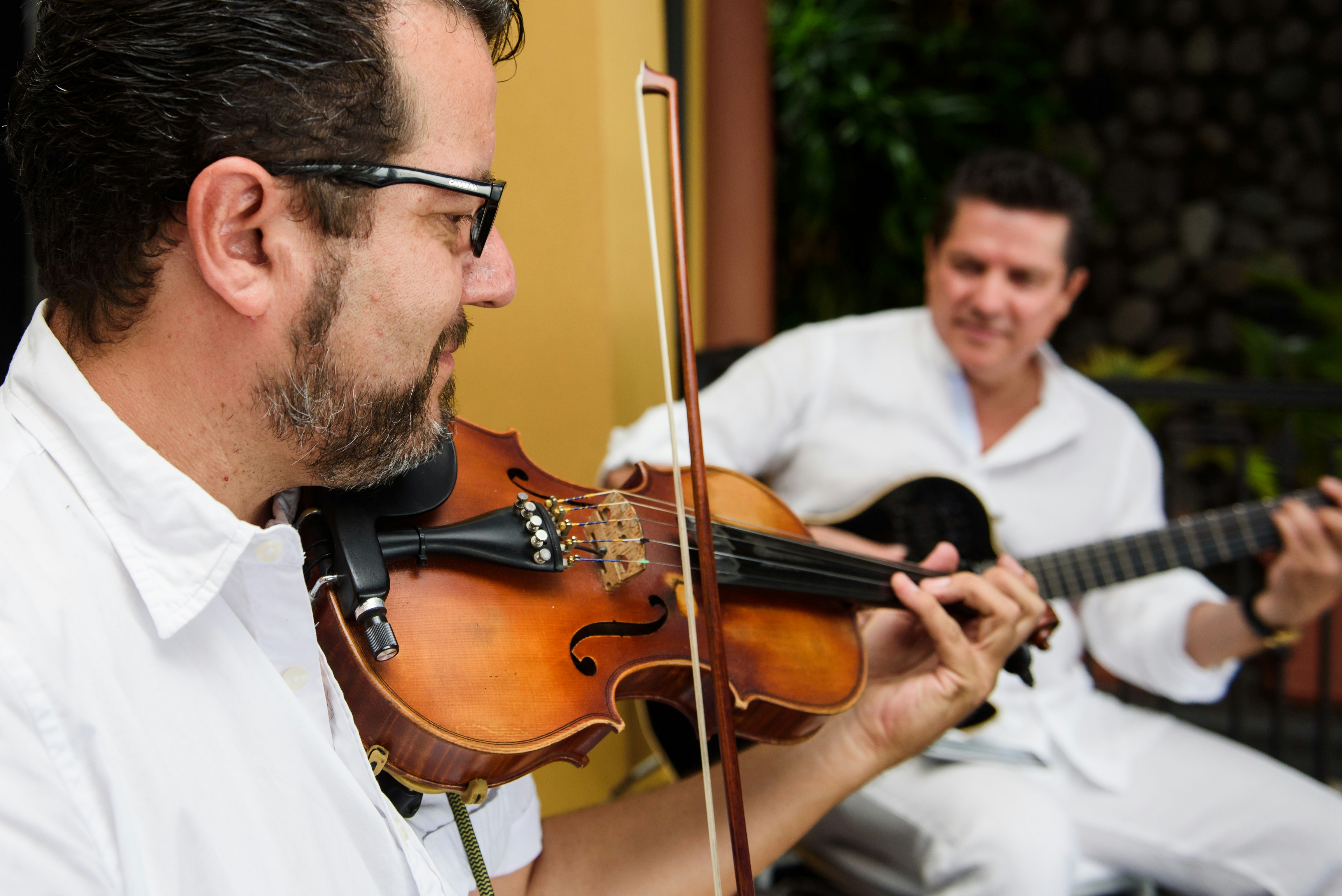 man in white dress shirt playing violin
