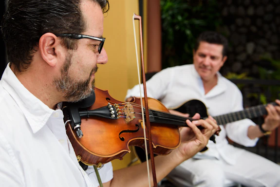 man in white dress shirt playing violin