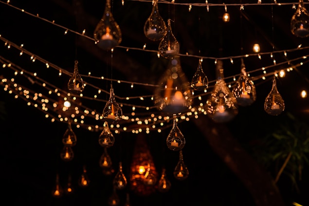 A warm gathering of holiday lighting enthusiasts sharing ideas under soft southwestern lighting.