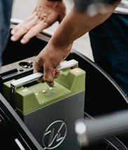 person holding black and green electronic device