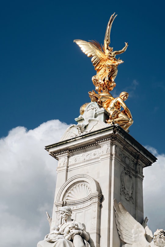 gold statue under blue sky during daytime in Victoria Memorial United Kingdom