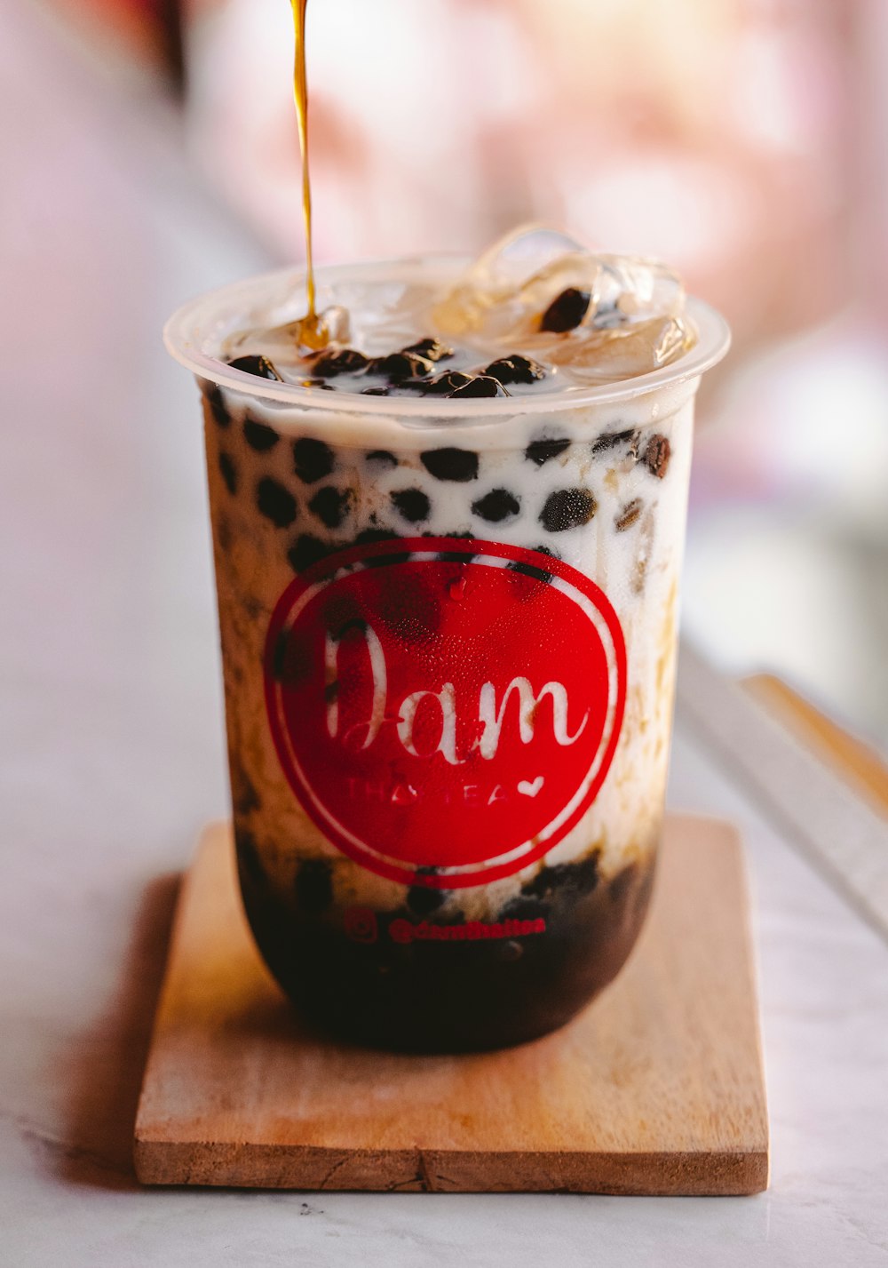 white and brown plastic cup with ice cream