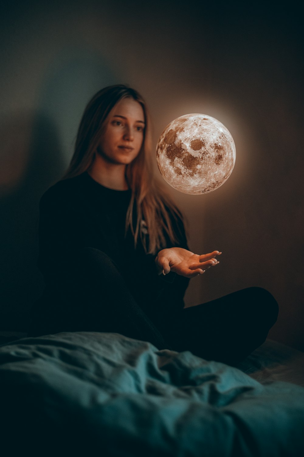 woman in black long sleeve shirt sitting on bed